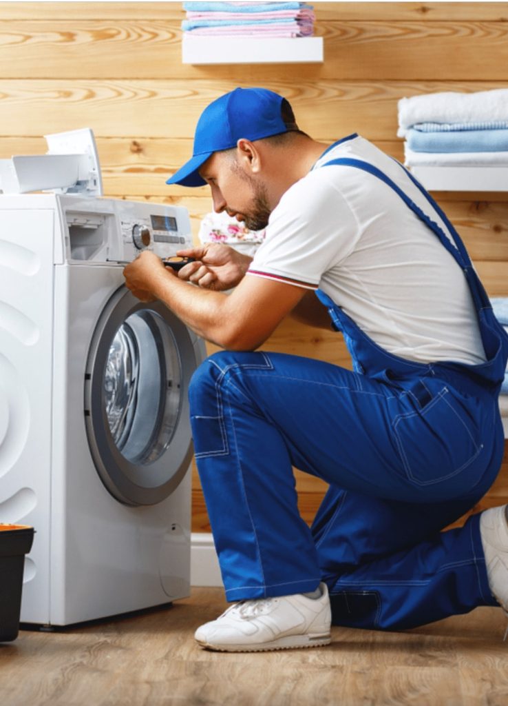 Iskander Services technician servicing a front-load washing machine
